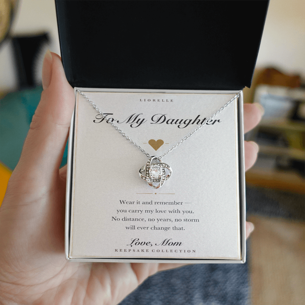 Personalized To My Daughter necklace held in hand — gift box open